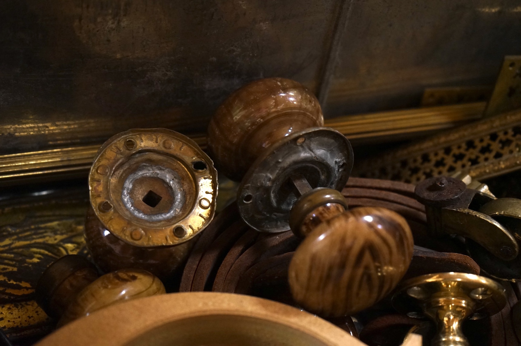 An Anglepoise lamp and metal door furniture and fittings in a tin trunk